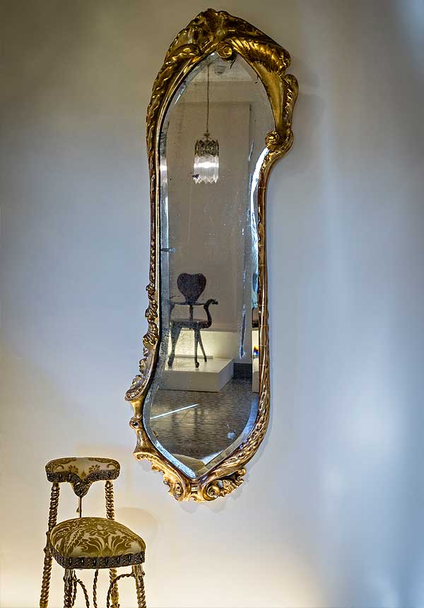 Mirror and 'voyeuse' chair from the living room on the main floor at Casa Calvet